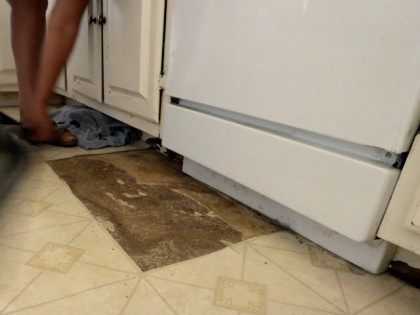 A leaky dishwasher has ruined a section of linoleum flooring.