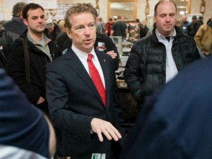 Republican presidential candidate, Sen. Rand Paul, R-Ky., center, meets with customers during a campaign stop at a gun show at Bektash Shrine Center, Saturday, Jan. 23, 2016, in Concord. (