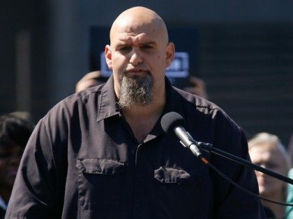 John Fetterman, the mayor of Braddock, Pa. addresses a crowd on the roof of his home during his announcement that he is running for the U.S. Senate on Monday, Sept. 14, 2015 in Braddock, Pa.(