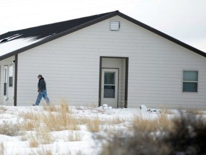 A member of the group occupying the Malheur National Wildlife Refuge headquarters, walks to one of its buldings Monday, Jan. 4, 2016, near Burns, Ore. The group calls itself Citizens for Constitutional Freedom and has sent a "demand for redress" to local, state and federal officials. Armed protesters took over …