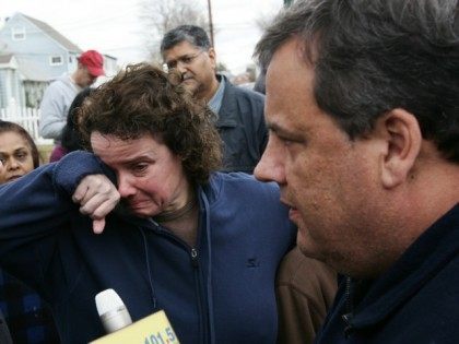 Annmarie Pansini, center, cries as New Jersey Gov. Chris Christie, right, speaks to her husband, Michael Pansini, during a tour of flood-ravaged Moonachie, N.J. Thursday, Nov. 1, 2012. The flooding of Moonachie, Little Ferry and Carlstadt, three communities sandwiched between Teterboro Airport, MetLife Stadium and the Hackensack River, was caused …