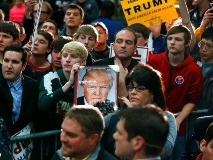 Audience members wait for Republican presidential candidate Donald Trump to pass during a