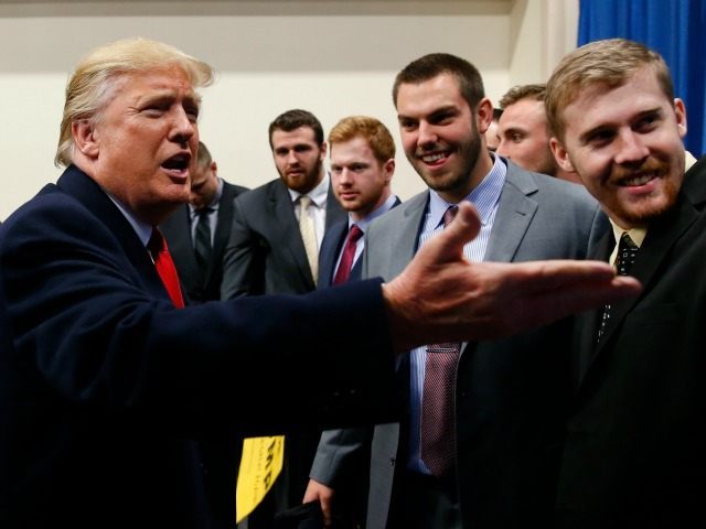 Republican presidential candidate Donald Trump speaks with University of Iowa football pla
