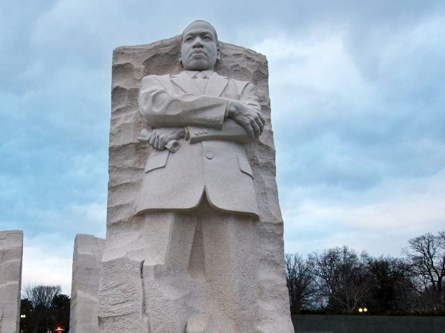 A lone microphone sits in front of a sculpture of Dr. Martin Luther King, Jr. at the Marti
