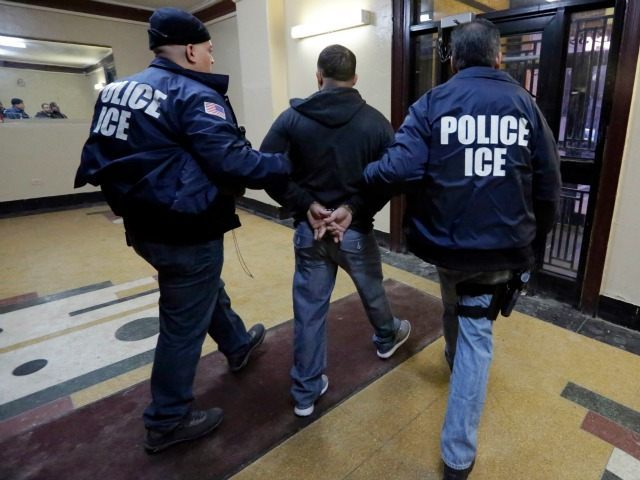 In this March 3, 2015 photo, Immigration and Customs Enforcement officers escort an arrest