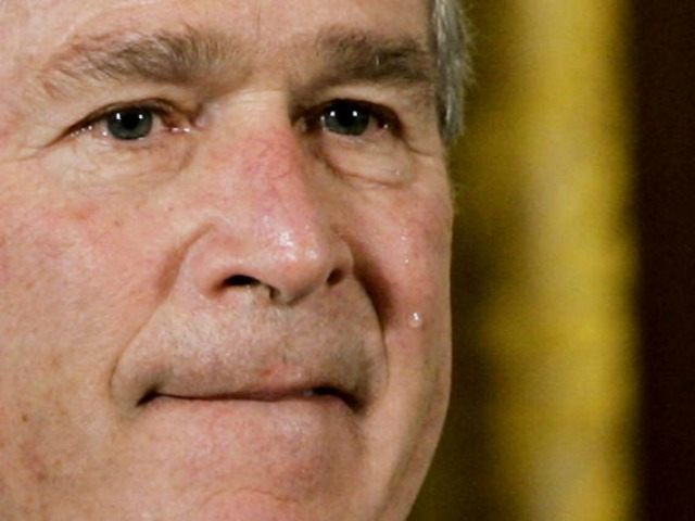 A tear runs down the cheek of U.S. President George W. Bush during a posthumous presentati
