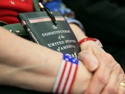 Myrna Beeber, from Guthrie County, Iowa, holds her Constitution as she listens to Republic