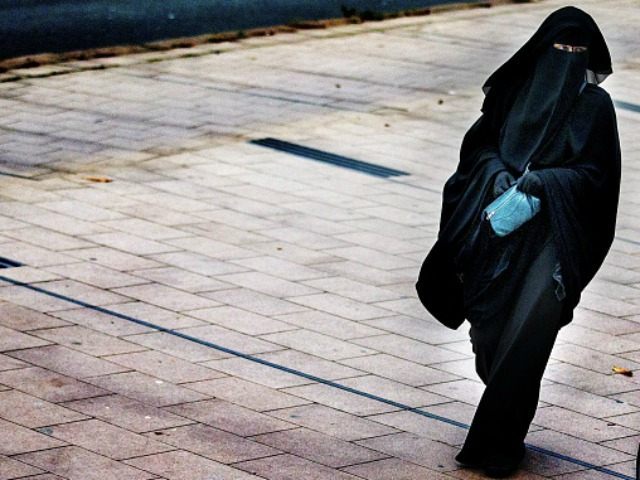 A woman wearing a burqa walks in The Hague on December 1, 2014. The Dutch cabinet approved