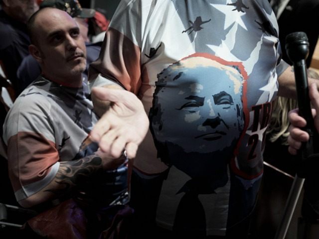 A supporter wears a t-shirt displaying the face of Donald Trump, president and chief execu
