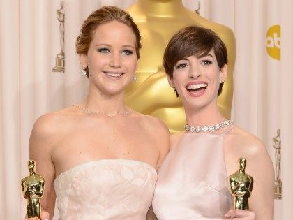 HOLLYWOOD, CA - FEBRUARY 24: (L-R) Actresses Jennifer Lawrence and Anne Hathaway pose in