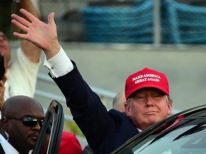 Republican Presidential candidate Donald Trump waves as leaves following a speech on board