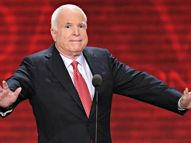McCain arms spread AP J. Scott Applewhite