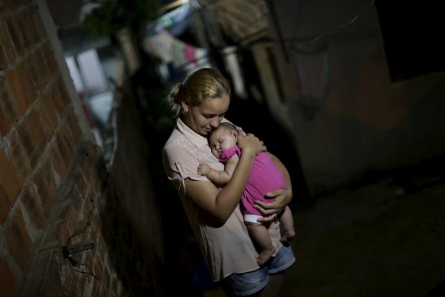 Gleyce Kelly embraces her daughter Maria Geovana, who has microcephaly, in Recife