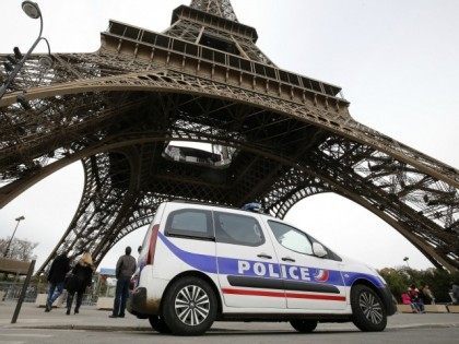 This photo taken on November 14, 2015 shows a police car stationed next to the Eiffel Tower in Paris.