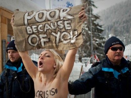 A topless Ukrainian protester is arrested by Swiss police after climbing up a fence at the entrance to the congress center where the World Economic Forum takes place in Davos, Switzerland Saturday, Jan. 28, 2012. The activists are from the group Femen, which has have become popular in Ukraine for …