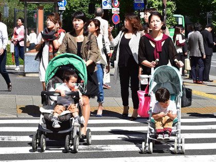 Japanese women push baby carts in Tokyo on October 2, 2015. Spending among Japanese househ