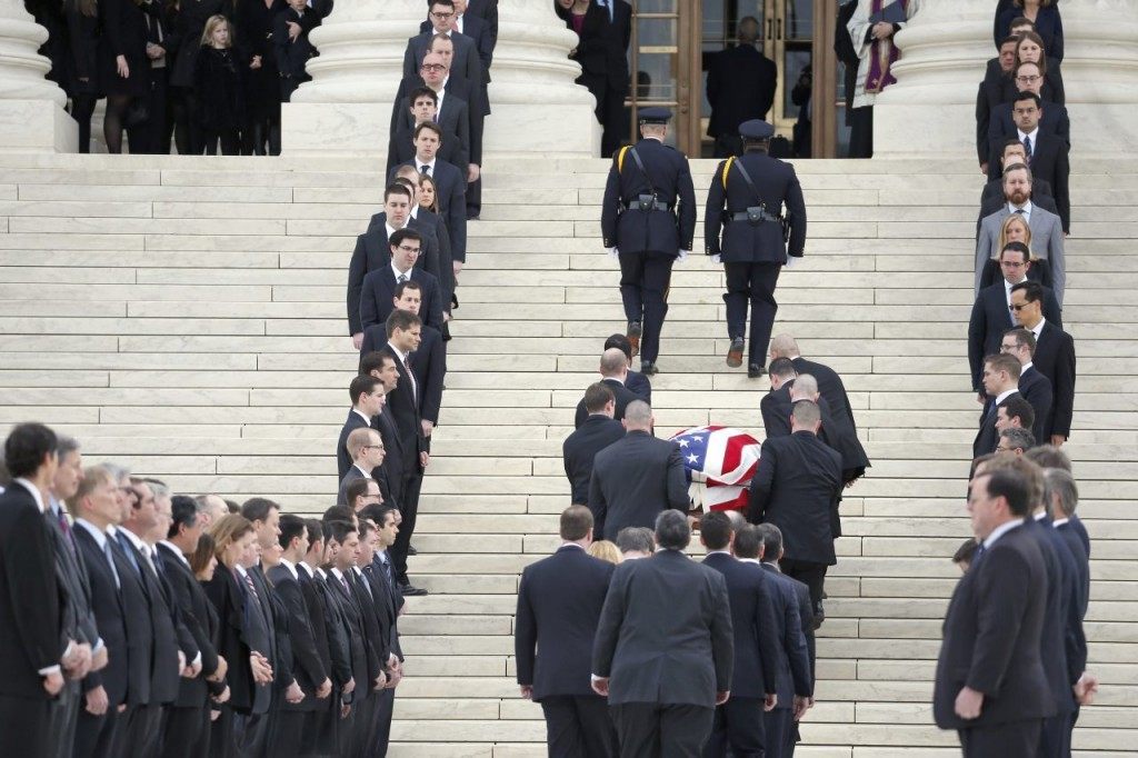 The body of Justice Antonin Scalia arrives at the Supreme Court in Washington, Friday, Feb. 19, 2016. Thousands of mourners will pay their respects Friday for Justice Antonin Scalia as his casket rests in the Great Hall of the Supreme Court, where he spent nearly three decades as one of its most influential members. (AP Photo/Alex Brandon)