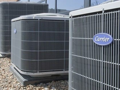 Air conditioners of the Carrier brand, a United Technologies company, are installed in Omaha, Neb., Tuesday, April 21, 2009. United Technologies Corp. said Tuesday its first-quarter profit fell 28 percent as the industrial conglomerate coped with falling orders related to the drop in office and residential construction. Declines were led …