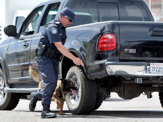 ** HOLD FOR CAMERON BLOCH/RELEASE DATE TBD** A U.S. Customs and Border Patrol agent runs his K-9 around a pickup truck in a search of weapons headed into Mexico Monday, May 4, 2009 at the Mariposa border crossing in Nogales, Ariz. President Barack Obama this spring promised his Mexican counterpart, …