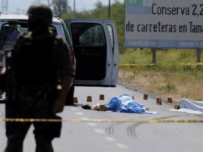 An army soldier stands guard at the crime scene where the candidate for governor of the st