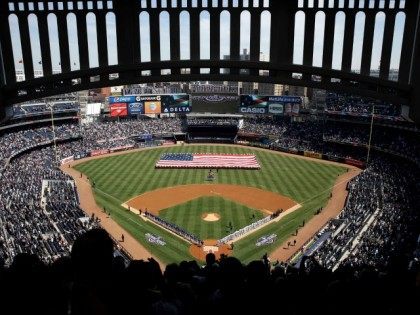 A large American flag is unfurled on the field at Yankee Stadium, Monday, April 6, 2015 in New York.
