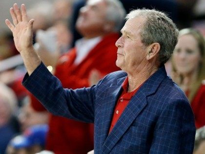 Former President George W. Bush waves to the crowd, December 2015.
