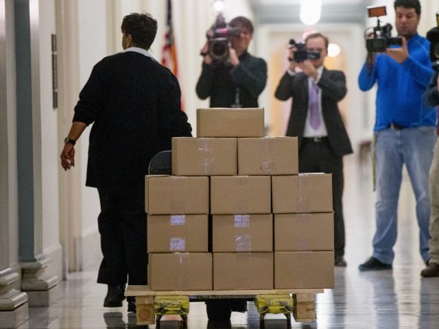 A staff member delivers President Barack Obama's fiscal 2017 federal budget to the Ho