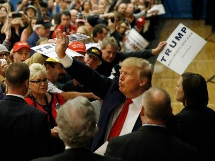 Republican presidential candidate Donald Trump waves during a campaign stop, Friday, Feb.