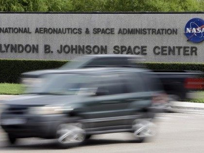 Cars pass by NASA's Johnson Space Center Tuesday, Oct. 1, 2013, in Houston. Most of the space center's employees are now on furlough because of the partial government shutdown. Those working to support the international space station continue to work. Congress plunged the nation into a partial government shutdown Tuesday …