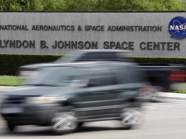Cars pass by NASA's Johnson Space Center Tuesday, Oct. 1, 2013, in Houston. Most of t
