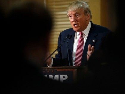 Republican presidential candidate Donald Trump speaks with members of the media during a n