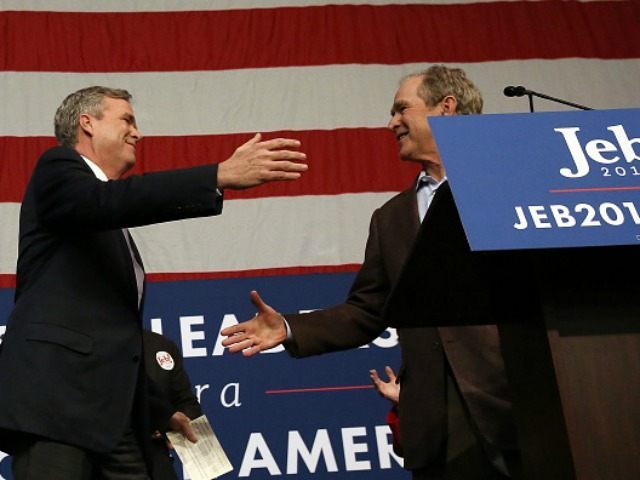 epublican presidential candidate Jeb Bush (L) greets his brother, former President George