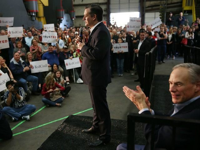 Texas Governor, Greg Abbott, (R) applauds as Sen. Ted Cruz (R-TX) speaks on February 24, 2