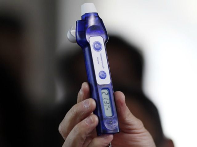 an electronic thermometer to test for Ebola