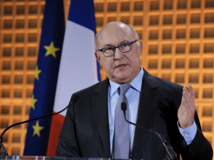 French Finance Minister Michel Sapin gestures as he delivers his New Year wishes to the pr