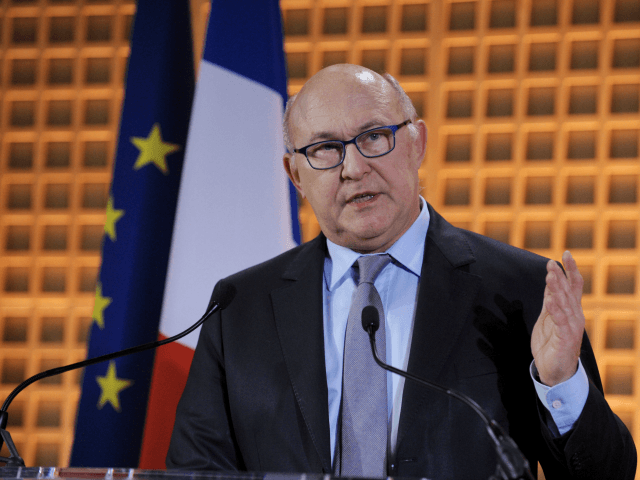 French Finance Minister Michel Sapin gestures as he delivers his New Year wishes to the pr