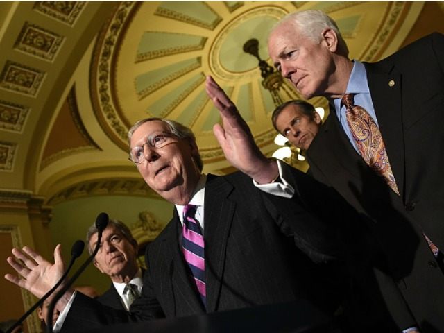 Senate Minority Leader Mitch McConnell (2nd L) (R-KY) answers questions November 18, 2014