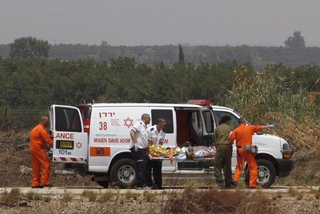 An Israeli rescue team evacuates an injured soldier following clashes which erupted along