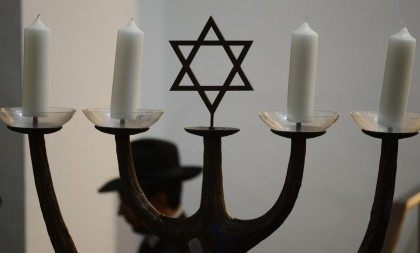 A man walks past a menorah during a ceremony to ordain four rabbis at the synagogue in Cologne, western Germany, on September 13, 2012