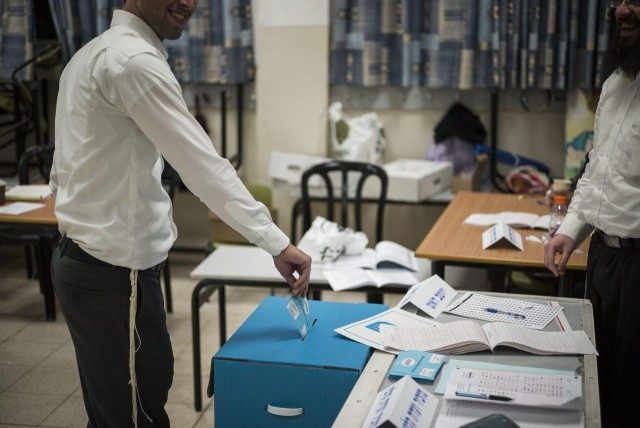An orthodox Jew casts his ballot on election day for the 20th Knesset on March 17, 2015 in