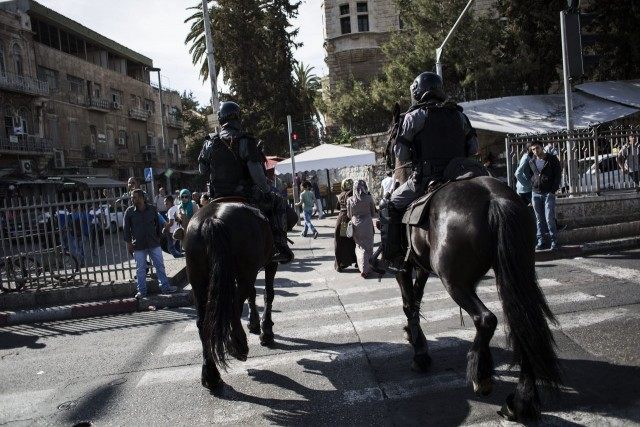 Palestinians clash with Police during rally marking Nakba day as police on horse back watc
