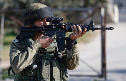 An Israeli soldier keeps watch at the site where a Palestinian man reportedly tried to ram