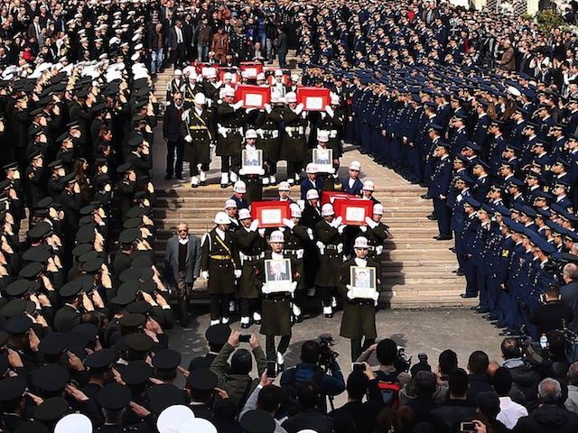 Honour guards carry the Turkish flag-draped coffins of car bombing victims during a funeral ceremony at Kocatepe Mosque in Ankara on February 19, 2016. Turkey has detained three more suspects over the attack on a convoy of military buses in Ankara that killed 28 people, prosecutors said on February 19, …