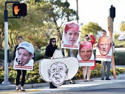 Supporters of Republican presidential candidate Donald Trump hold out signs at the entranc