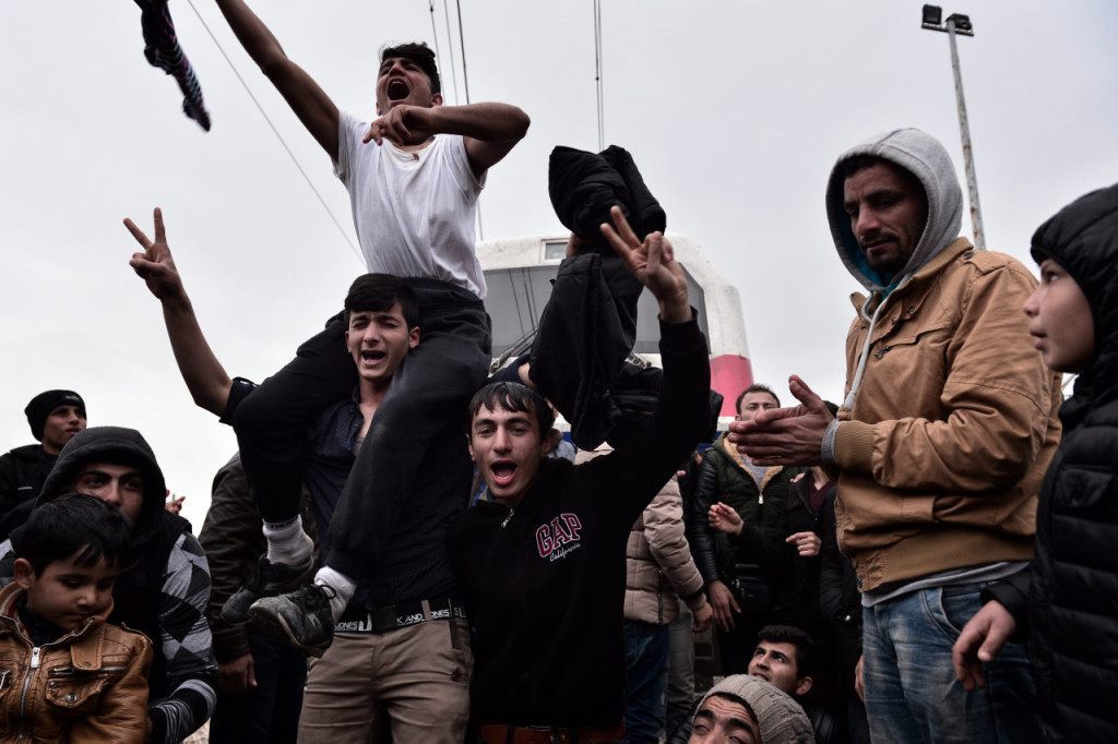 Syrian and Iraqi refugees trapped at the Greek-Macedonian border block an arriving train during their protest demanding the opening of the borders on February 28, 2016. More than 5,000 people were trapped at the Idomeni camp after four Balkan countries announced a daily cap on migrant arrivals. Slovenia and Croatia, both EU members, and Serbia and Macedonia said they would restrict the number of daily arrivals to 580 per day. / AFP / LOUISA GOULIAMAKI (Photo credit should read LOUISA GOULIAMAKI/AFP/Getty Images)