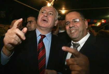 Likud party leader Benjamin Netanyahu (L) is greeted by his host and party colleague Ayoub