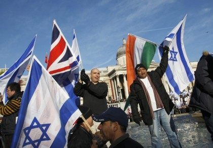 Jews stand on the fountain sides in Trafalgar Square to cheer and wave their flags during a rally in London, on January 11, 2009. Thousands of British Jews attended the rally to condemn Hamas and call for peace for Israeli and Gazan citizens.