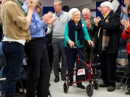 People stand and applaud as Republican presidential candidate, former Florida Gov. Jeb Bush arrives with his mother Barbara Bush to a town hall meeting at West Running Brook Middle School in Derry, N.H., Thursday Feb. 4, 2016. (AP Photo/Jacquelyn Martin)