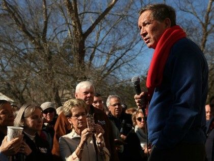 Ohio Governor and Republican presidential candidate John Kasich speaks to voters outside of a restaurant in South Carolina following his second place showing in the New Hampshire primary on February 11, 2016 in Pawleys Island, South Carolina.