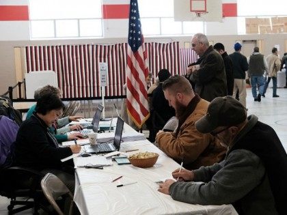 People vote inside of a middle school serving as a voting station on the day of the New Ha